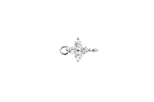 Silver ring with a star-shaped diamond on a light marble background