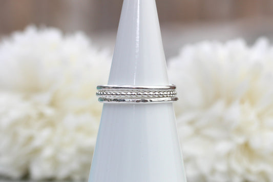Silver ring on a white cone with a blurred white floral background