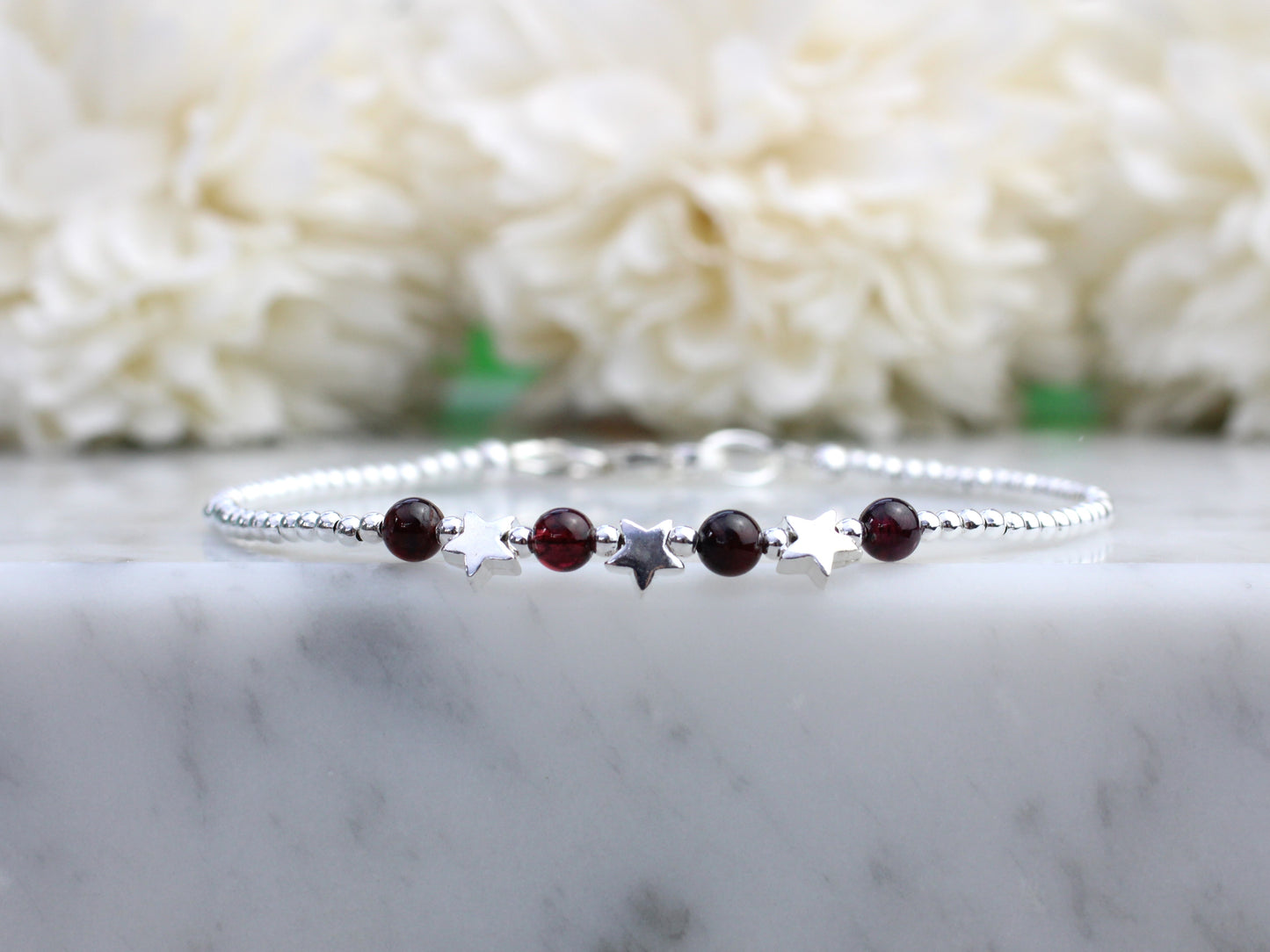 Star bracelet with natural garnet beads.