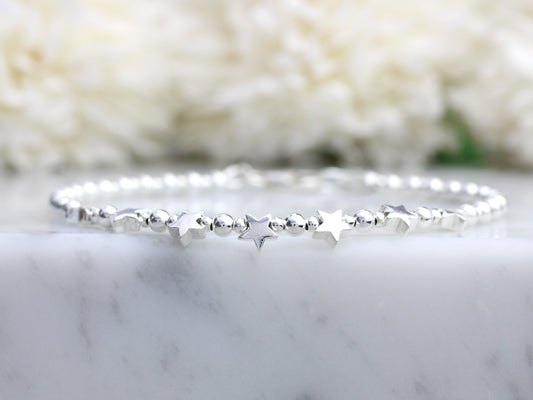 star bracelet on a marble surface