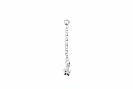 Silver chain with a flower charm on a marble background