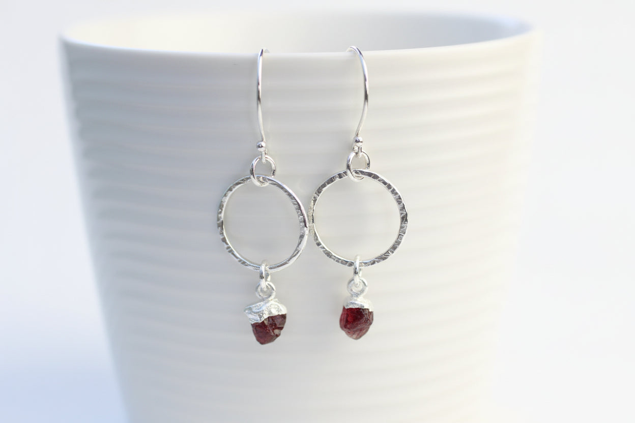 Sterling silver hoop earrings with raw garnet gemstone.