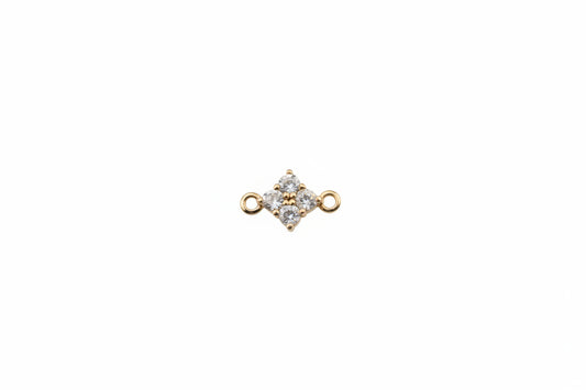 Gold and gemstone jewelry piece on a marble background