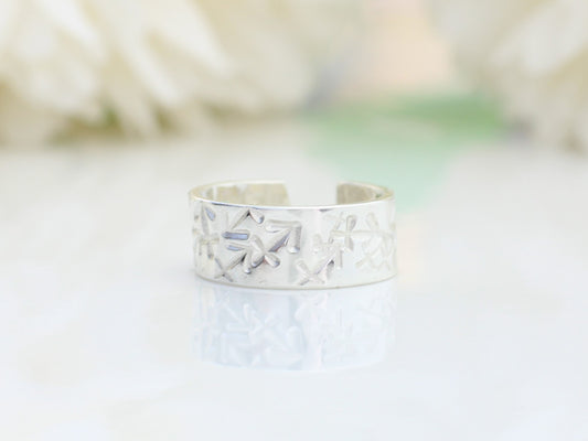 silver ear cuff on a white surface