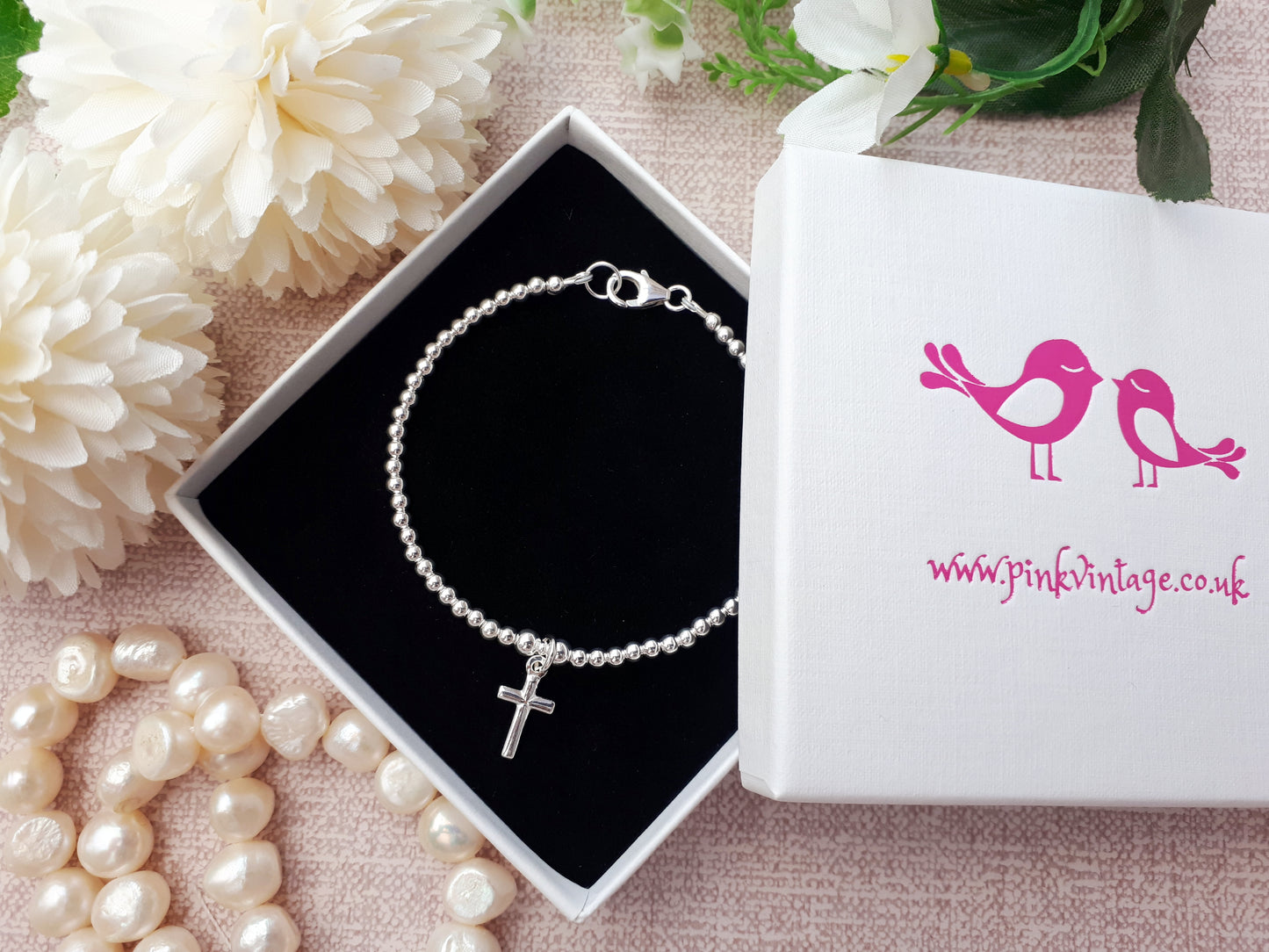 Silver beaded cross bracelet.