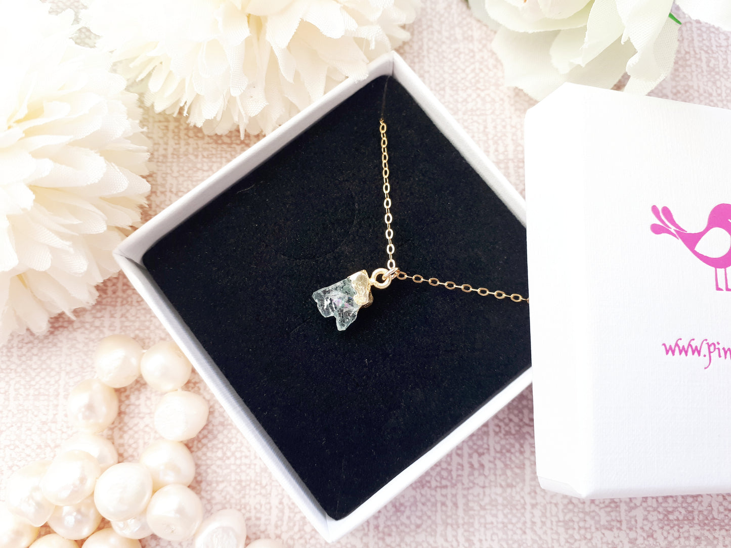 Raw aquamarine necklace in gold.