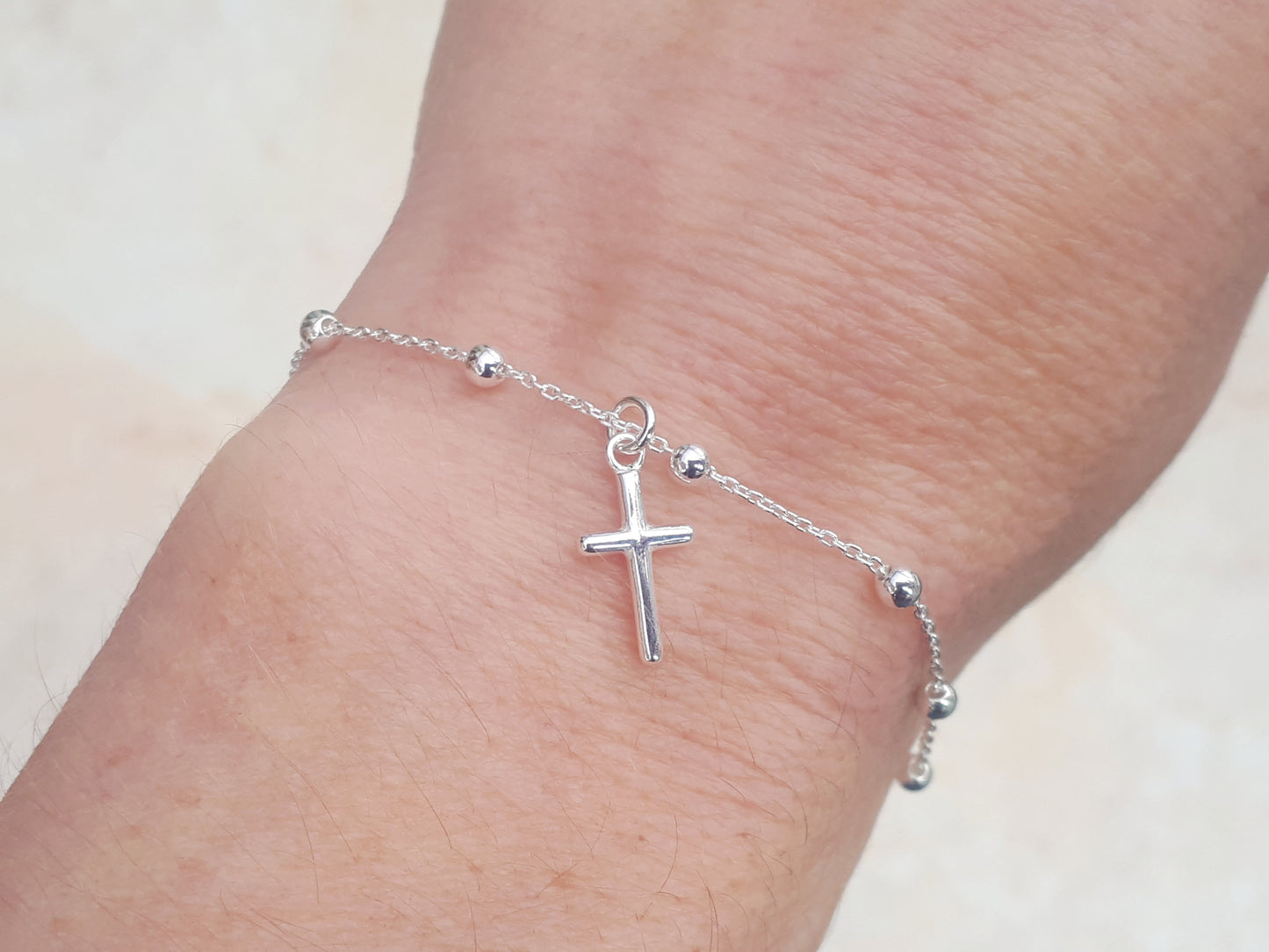 Sterling silver adjustable cross bracelet.