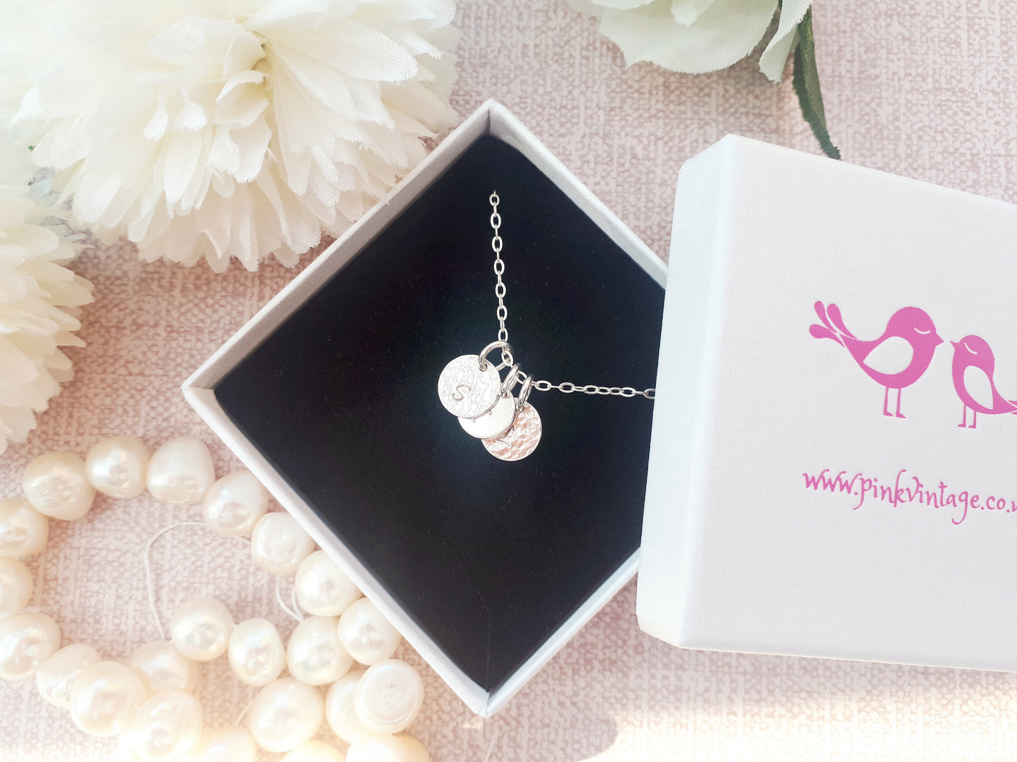 Family initial necklace in sterling silver.