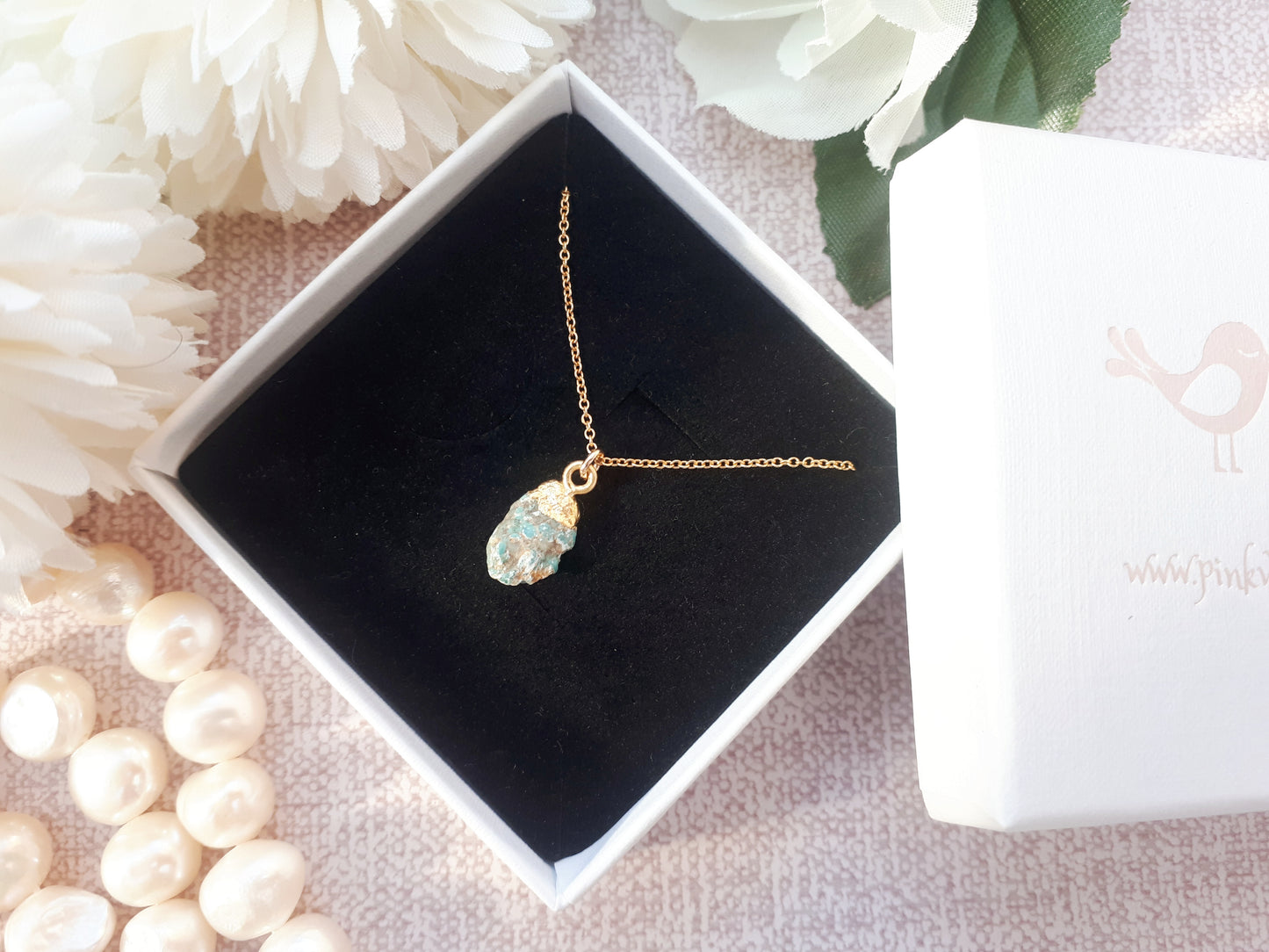 Raw turquoise necklace in gold.