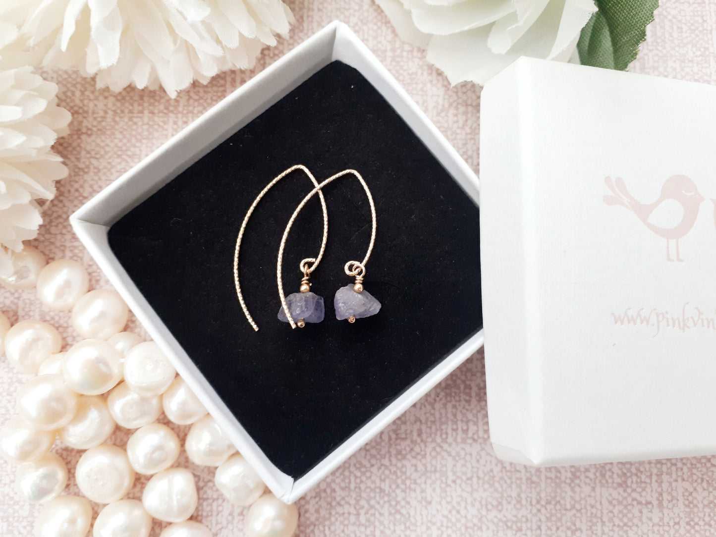 Raw tanzanite earrings in gold.