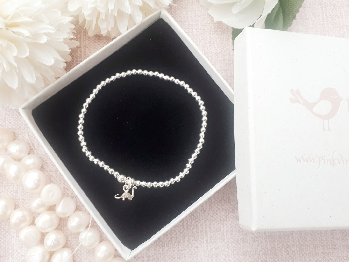 Silver dinosaur bracelet.