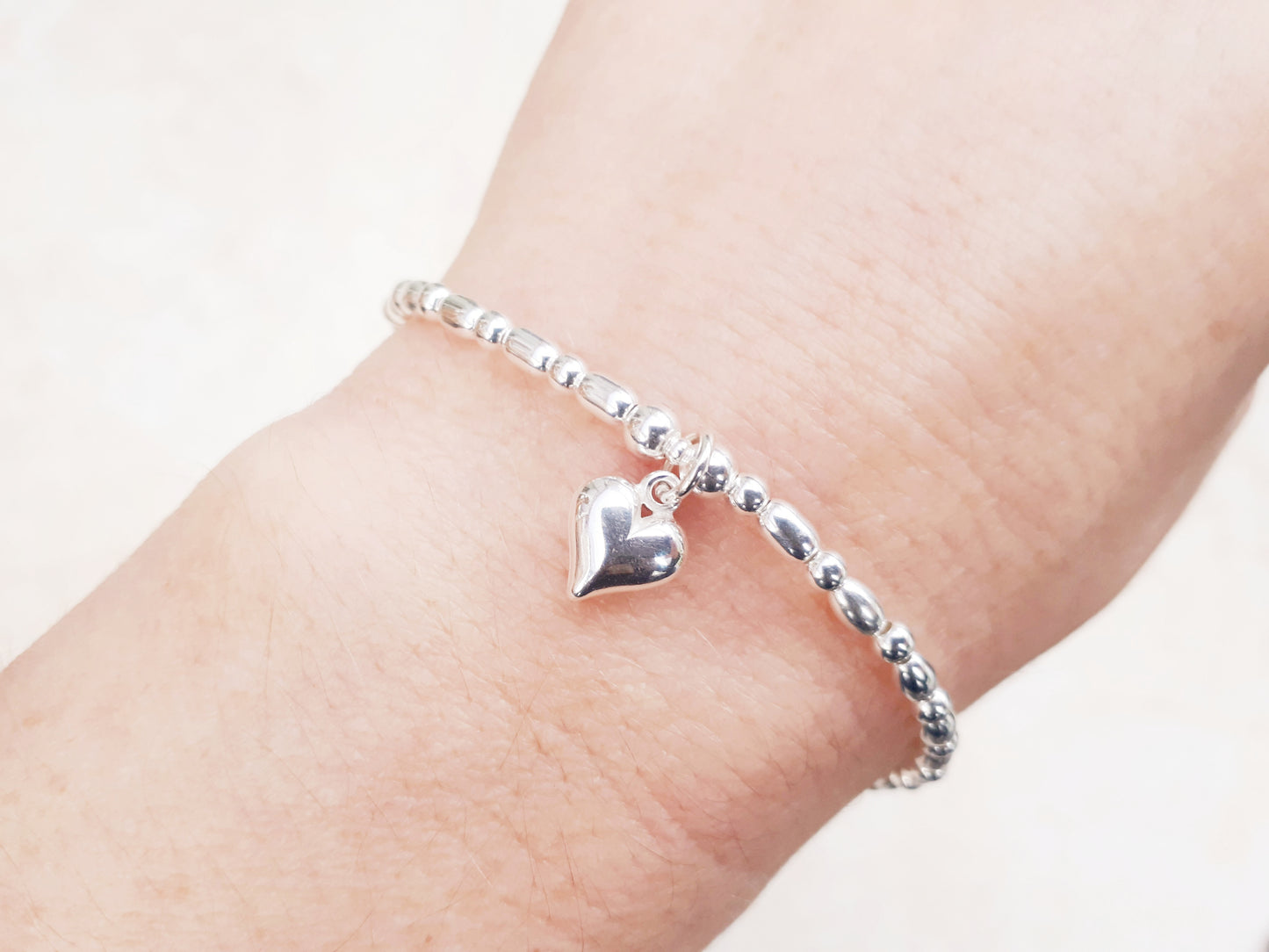 Sterling silver bead bracelet with love heart charm, can be personalised. Also available as a stretch bracelet.
