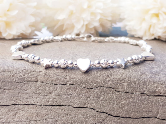Sterling silver bead bracelet with hearts and stars.