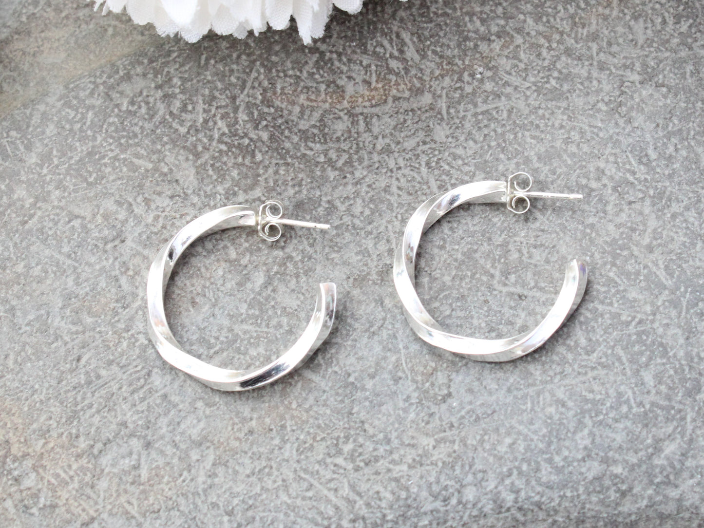 Handmade sterling silver twisted hoop earrings.