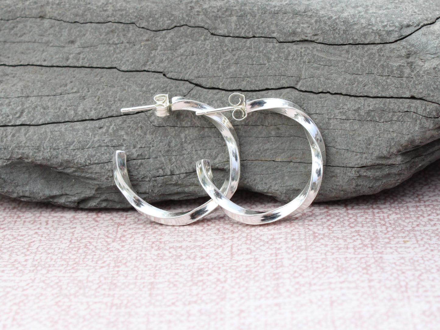 Handmade sterling silver twisted hoop earrings.