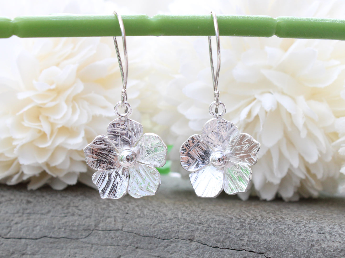 Flower drop earrings in sterling silver.