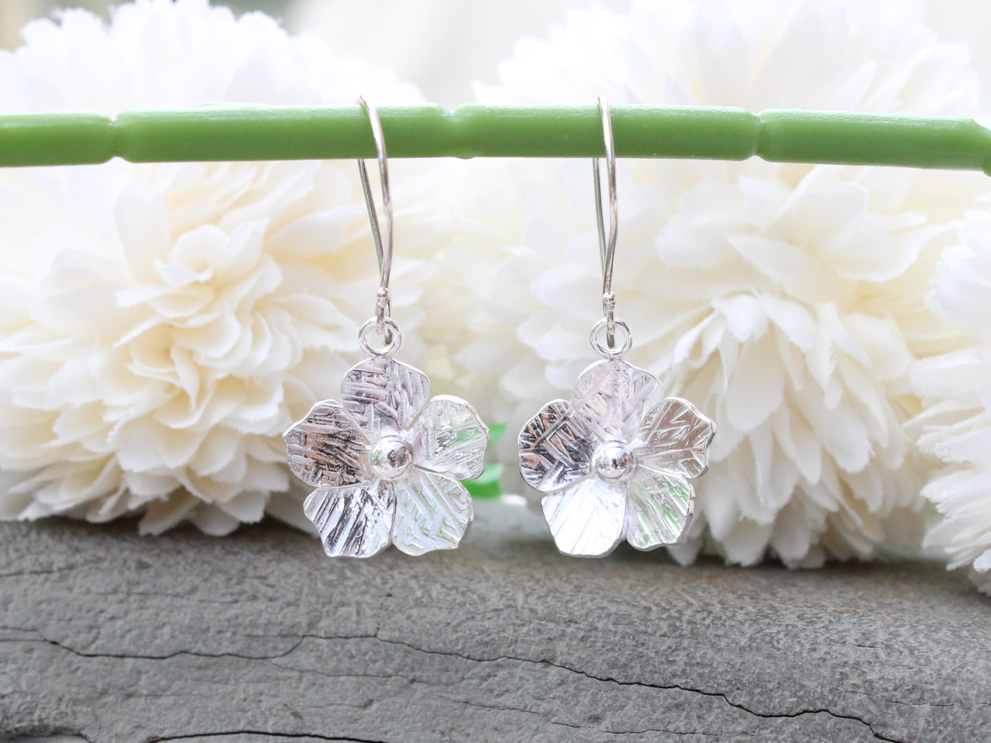 Flower drop earrings in sterling silver.