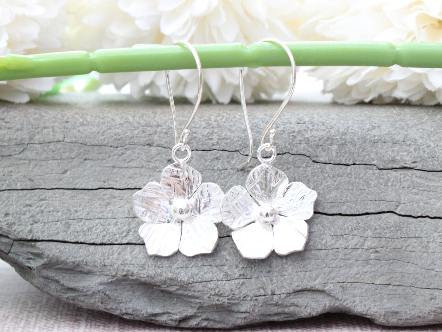 Flower drop earrings in sterling silver.