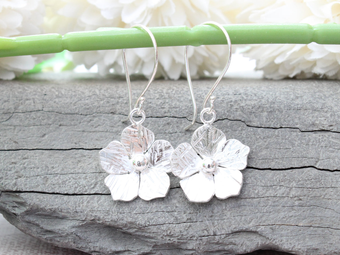 Flower drop earrings in sterling silver.