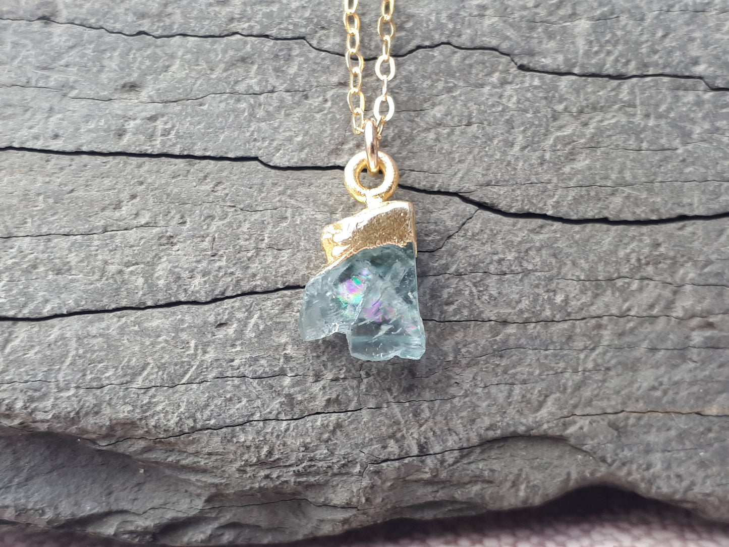 Raw aquamarine necklace in gold.
