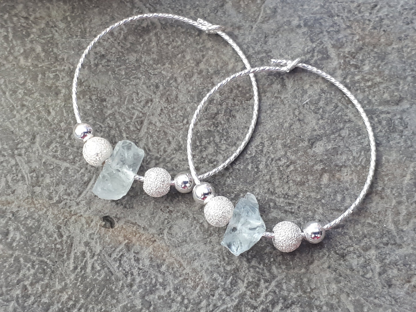 Raw aquamarine hoop earrings in sterling silver.