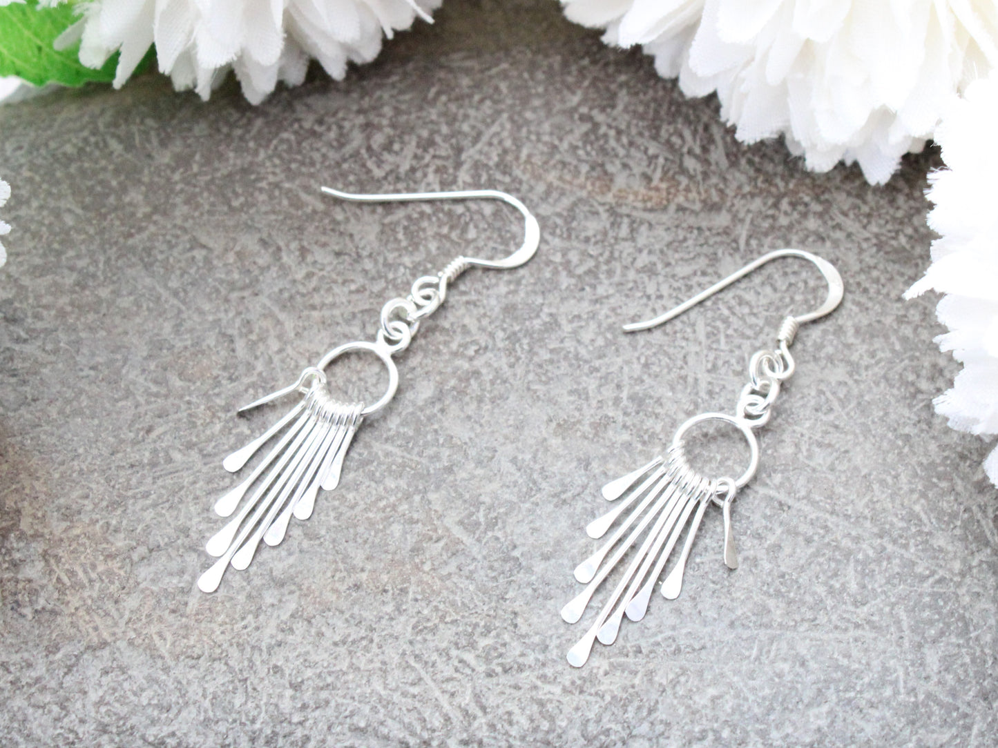 Silver tassel earrings.