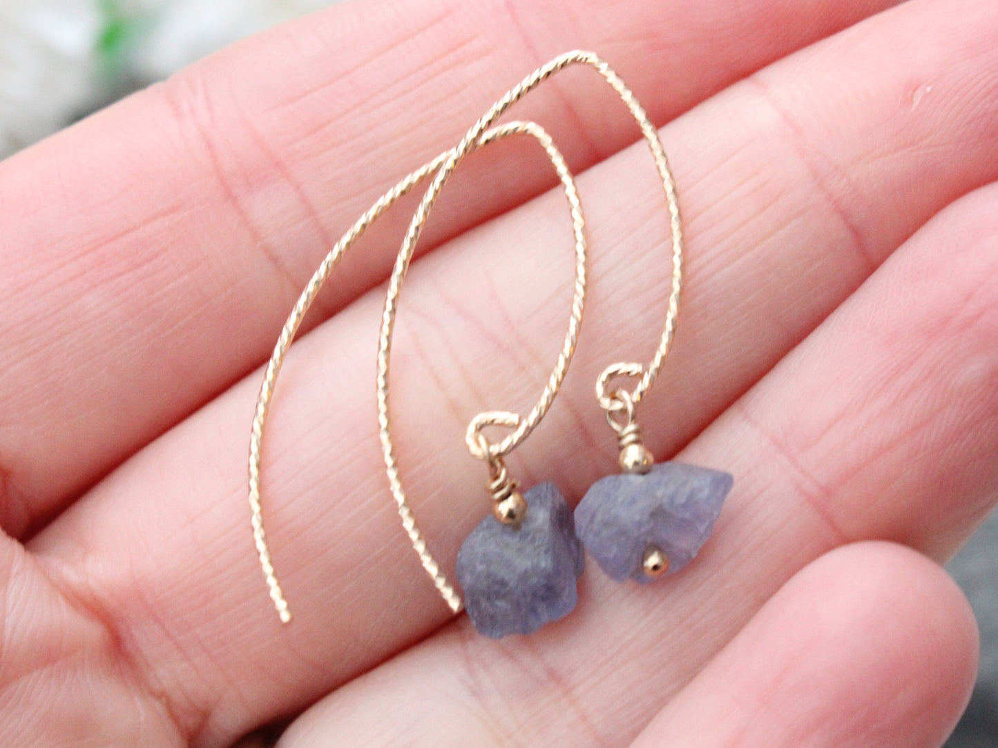 Raw tanzanite earrings in gold.