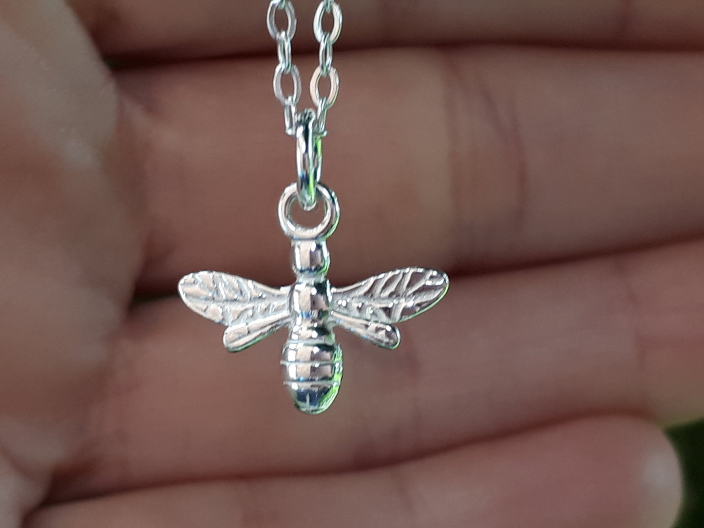 Silver bee necklace.